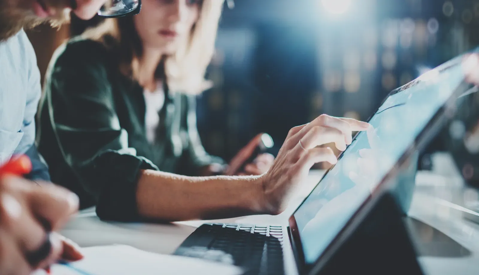 Colleagues reviewing a digital interface together at a workstation