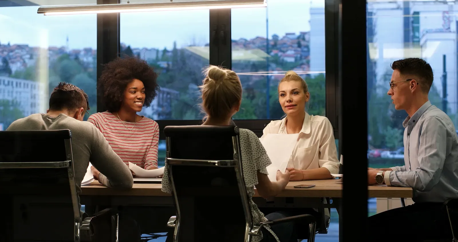 A group gathered around a table for a collaborative business workshop